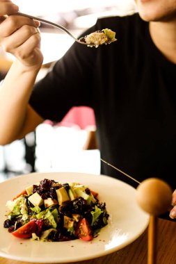 çekici beyaz salata, odak üstünde el yemek kadın ve çatal gülümseyen portresi.