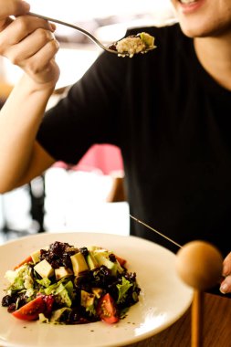 çekici beyaz salata, odak üstünde el yemek kadın ve çatal gülümseyen portresi.