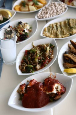 Özel Alkollü İçkili Rakılı Türk ve Yunan Geleneksel Yemek Masası. Uzo ve Türk Rakısı, Türkiye, Yunanistan, Kıbrıs ve Lübnan'da yaygın olarak tüketilen kuru anason aromalı bir aperatiftir.