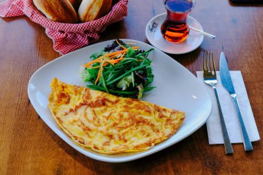 Lezzetli omlet ve kahvaltı tabağı masada..