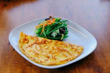 Lezzetli omlet ve kahvaltı tabağı masada..