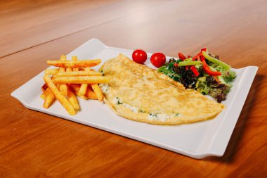 Lezzetli omlet ve kahvaltı tabağı masada..