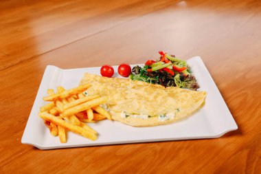 Lezzetli omlet ve kahvaltı tabağı masada..