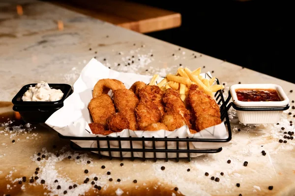 delicious breaded chicken fingers on the table