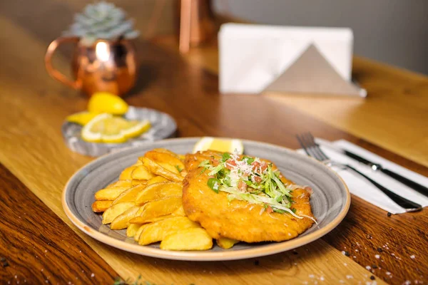 Patates kızartmasıyla servis edilen lezzetli şnitzel.