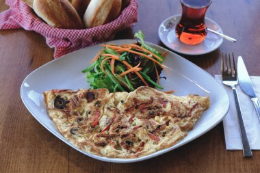 Lezzetli omlet ve kahvaltı tabağı masada..