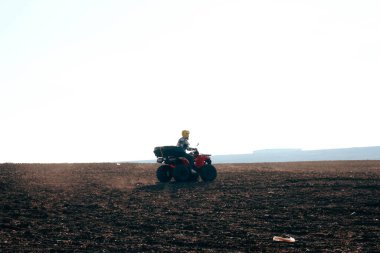 helmet sitting on atv quad bike in mountains
