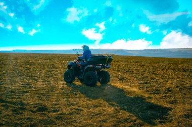 helmet sitting on atv quad bike in mountains