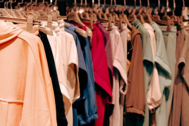 Giysiler mağazadaki rafta asılı.