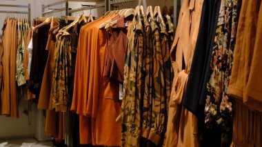 Giysiler mağazadaki rafta asılı.