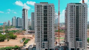 Bat-Yam, Israel, July 11, 2022.Aerial view of the construction of new comfortable apartments on the Mediterranean coast in Israel. The new residential area of skyscrapers. High-quality 4k footage