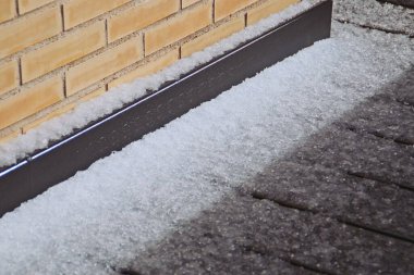 Hailstones on the floor of an attic terrace. Accumulated hail after a hailstorm fell in Madrid on April 6, 2019.