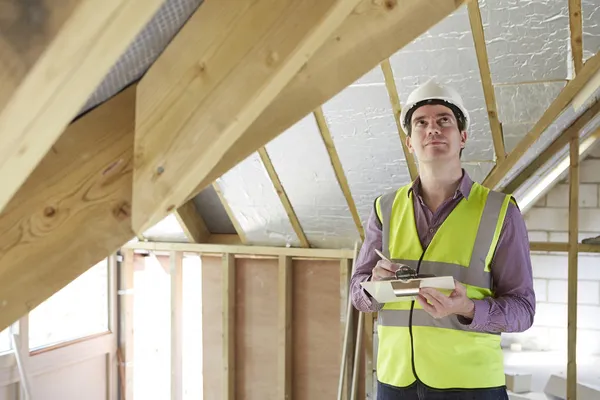 Building Inspector Looking At New Property Stock Photo