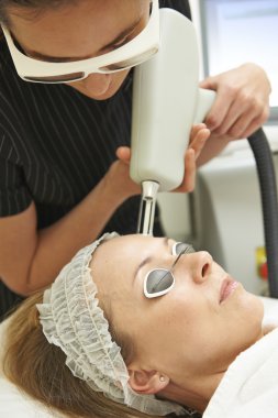 Beautician Carrying Out Fractional Laser Treatment clipart