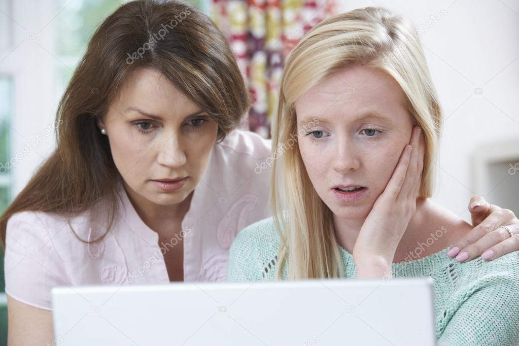 Mother Comforting Daughter Victimized By Online Bullying