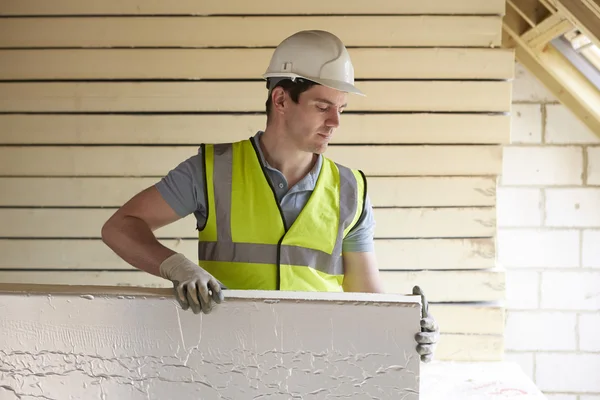 Builder Fitting Insulation Boards Into Roof Of New Home — Stock Photo, Image