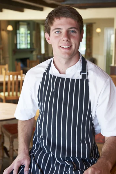 Chef Wearing Whites And Apron Sitting In Restaurant — Stock Photo, Image