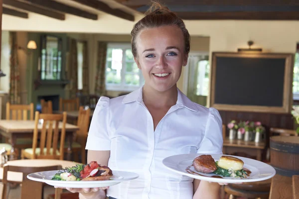 Portrait Of Waitress Serving Food In Restaurant — Stock Photo, Image
