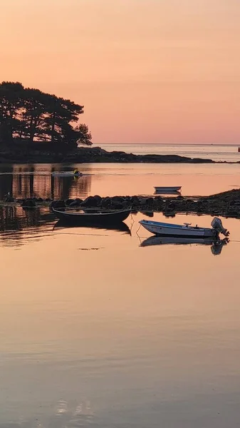 Sunrise overlooking islands in Marblehead Harbor with motorboats in foreground