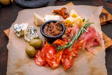 Cheese plate with sliced meat italian food on the board