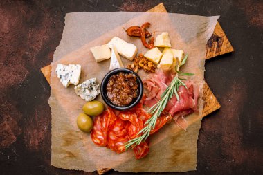 Cheese plate with sliced meat italian food on the board