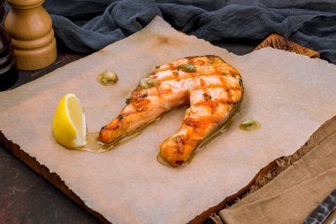 Salmon steak on the grill on the board