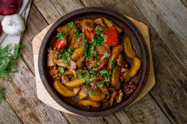 Roast beef and vegetables on wooden table