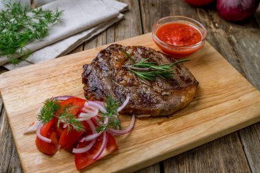 juicy Ribeye steak on wooden table