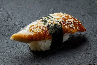 sushi eel on black concrete