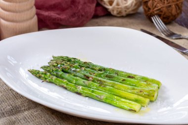 big green Asparagus grill on a white plate