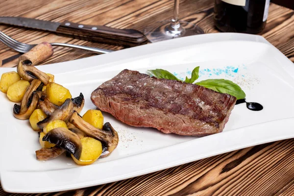 roast beef Steak, flank steak with grilled mushrooms on white plate