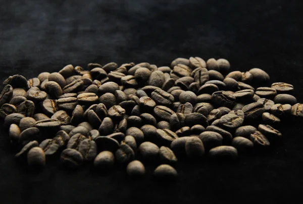coffee beans in the dark on a dark background. blur