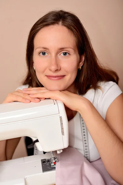 Young attractive woman sewing — Stock Photo, Image