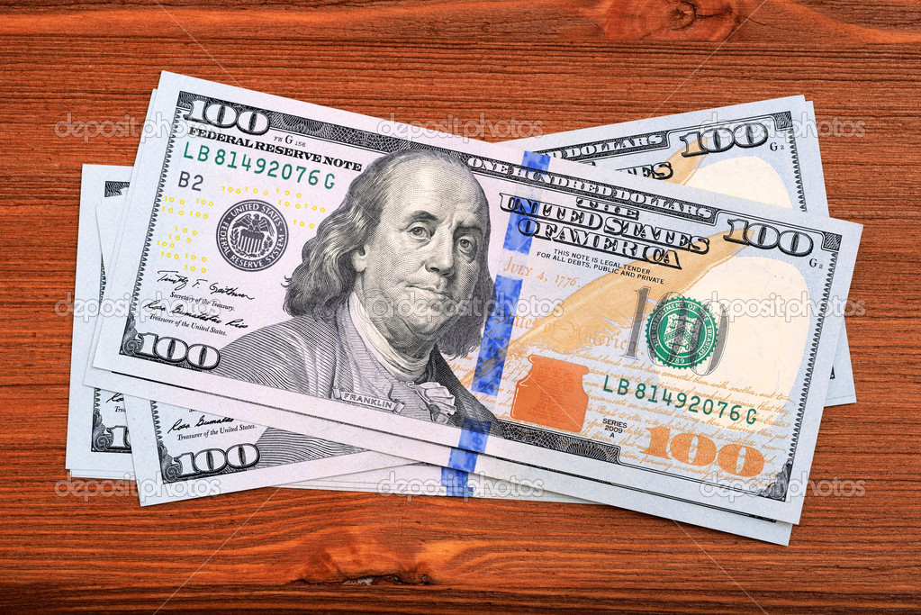American dollars banknotes on wooden table