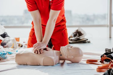 26.03.2022 Kyiv, Ukraine: CPR training medical procedure, Demonstrating chest compressions on CPR doll in the office of modern company