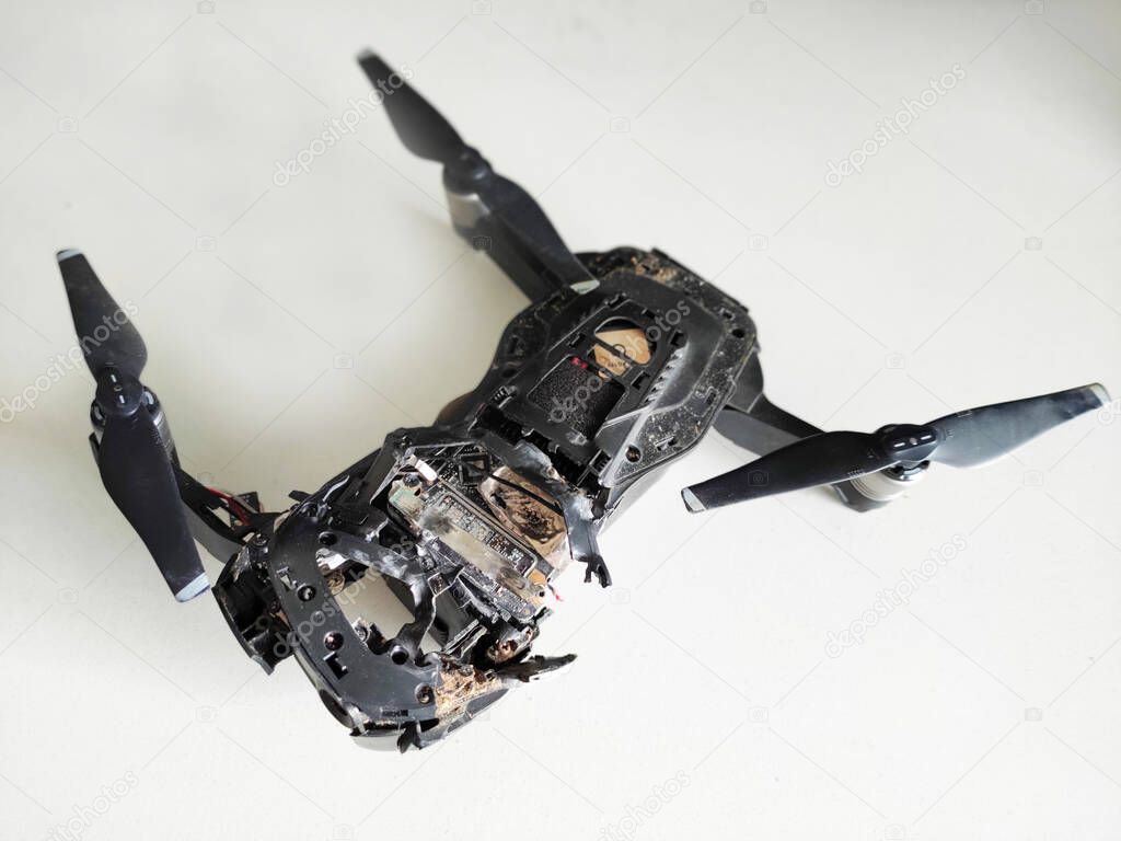 Drone Shot Down With A Shotgun Broken Black Quadcopter Lying On White Background