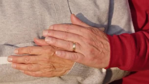 Senior Caucasian married couple hugging covering their hands closeup — Stock Video