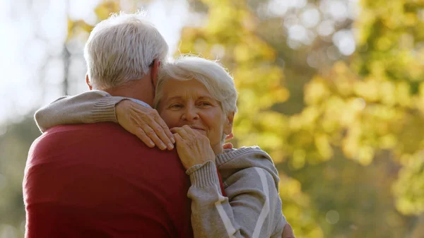 Embrace Two Caucasian Seniors Man Red Sweater Seen Back His —  Fotos de Stock