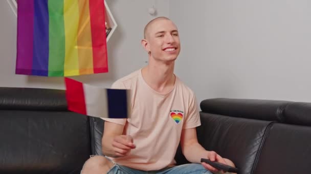 French Caucasian Bald Lgbtqai Activist Waving French Flag While Sitting — Stockvideo
