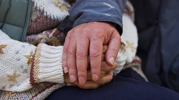 Support in illness concept. Wrinkled hands of two caucasian elderly senior people touching each other. — Stok fotoğraf