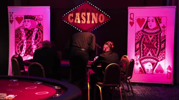 10.28.2019 Warsaw, Poland People in black clothes sitting by a table in a casino enjoying their evening. Gambling addiction concept. — Stok video