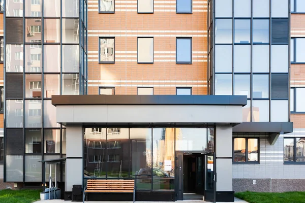 Entrada a un edificio de apartamentos de vidrio y metal, construcción moderna — Foto de Stock