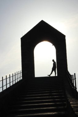 Köprünün tepesindeki bir adamın gölgesi.