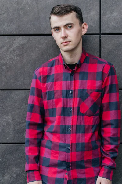 young handsome guy in a red checkered shirt