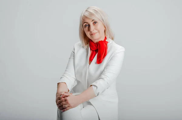 Woman Sitting Chair White Suit Red Scarf — Stockfoto