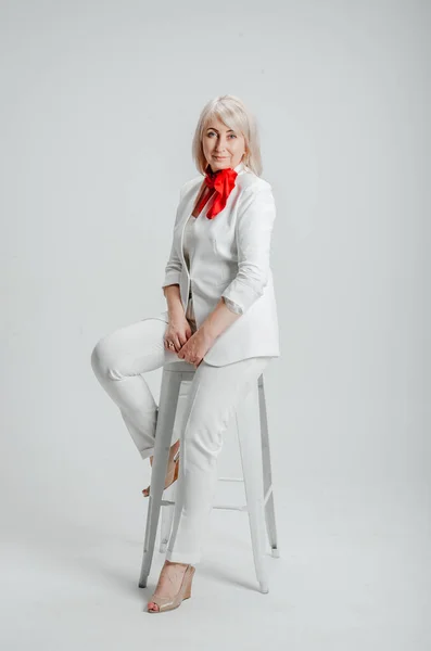 Woman Sitting Chair White Suit Red Scarf — Stockfoto