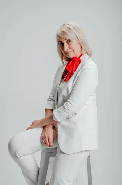 Woman Sitting Chair White Suit Red Scarf — Stockfoto