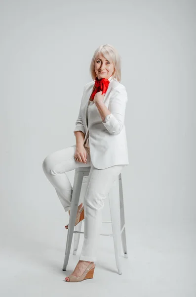 Woman Sitting Chair White Suit Red Scarf Fotografia Stock