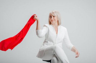 a woman in a white suit with a red scarf on a white background