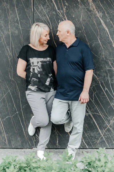 man and woman in dark t-shirts on the street